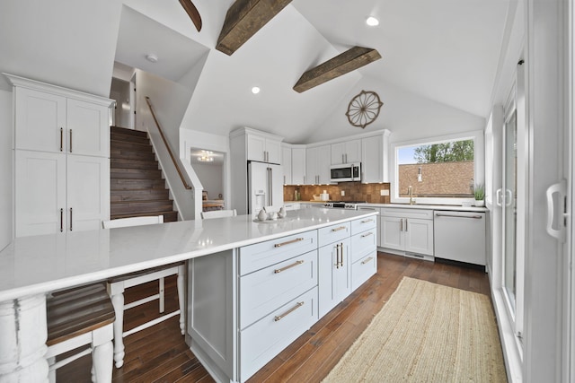 282 Evans Trl, Tipton, MI 49287 - kitchen with white appliances, white cabinetry, light countertops, decorative backsplash, and beam ceiling