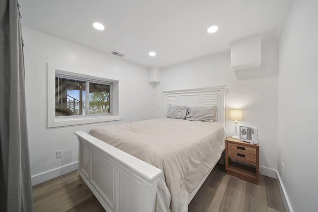 282 Evans Trl, Tipton, MI 49287 - bedroom featuring dark wood-style floors, baseboards, and recessed lighting
