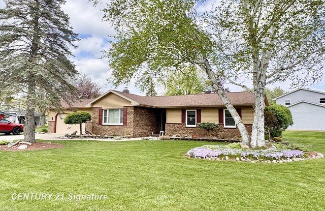2880 Wurtzel Dr, Freeland, MI 48623 - ranch-style house with brick siding and a front lawn