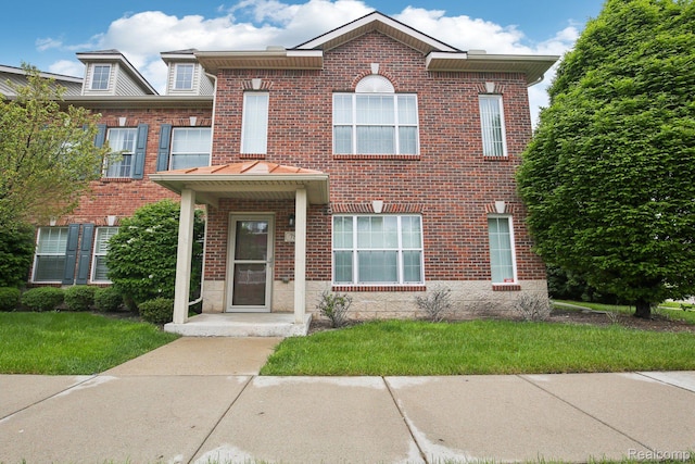 781 2nd St Unit 61, Wyandotte, MI 48192 - view of front of property with brick siding and a front lawn