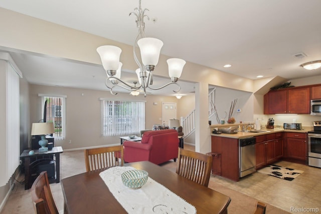 781 2nd St Unit 61, Wyandotte, MI 48192 - dining area featuring a chandelier, recessed lighting, baseboards, and a wood stove
