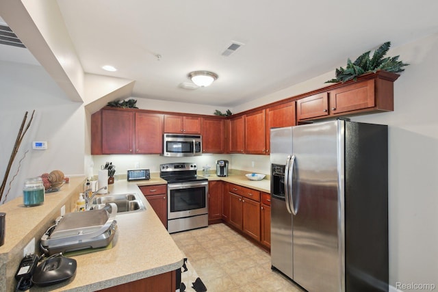 781 2nd St Unit 61, Wyandotte, MI 48192 - kitchen with appliances with stainless steel finishes, a sink, light countertops, recessed lighting, and light flooring