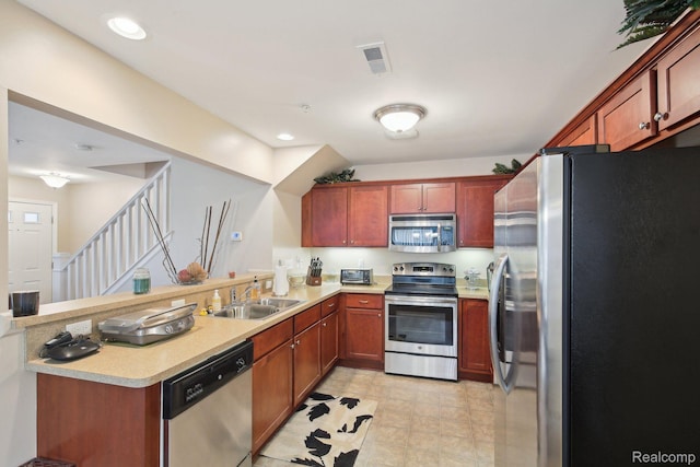 781 2nd St Unit 61, Wyandotte, MI 48192 - kitchen with stainless steel appliances, a sink, a peninsula, light countertops, and recessed lighting