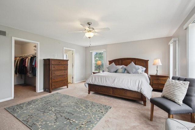 781 2nd St Unit 61, Wyandotte, MI 48192 - bedroom featuring carpet, a walk in closet, a ceiling fan, a closet, and baseboards