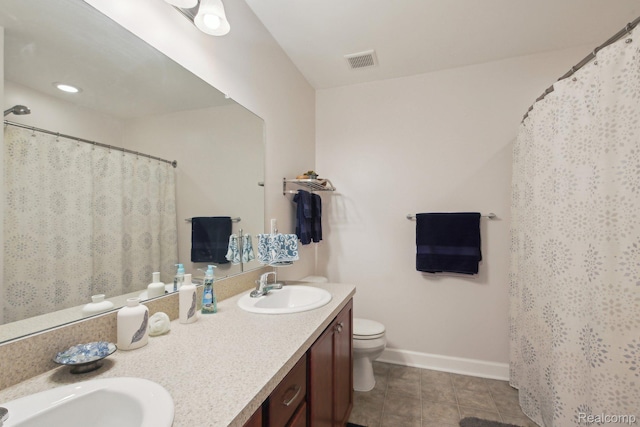 781 2nd St Unit 61, Wyandotte, MI 48192 - bathroom with double vanity, tile patterned floors, toilet, baseboards, and a shower with shower curtain