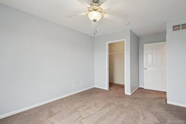 781 2nd St Unit 61, Wyandotte, MI 48192 - unfurnished bedroom featuring carpet floors, baseboards, a closet, a walk in closet, and a ceiling fan