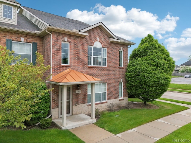 781 2nd St Unit 61, Wyandotte, MI 48192 - view of front facade with brick siding and a front yard