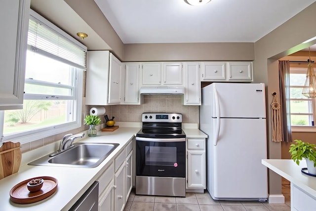 1522 Brentwood Dr, Troy, MI 48098 - kitchen with stainless steel appliances, under cabinet range hood, a sink, white cabinetry, and light countertops