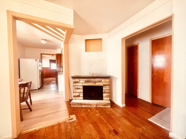 20760 Atlantic Ave, Warren, MI 48091 - unfurnished living room with wood finished floors and a fireplace