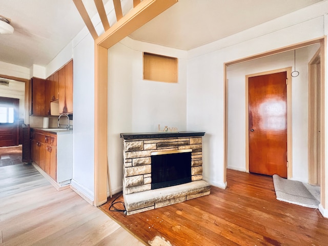 20760 Atlantic Ave, Warren, MI 48091 - living room with light wood-style floors and a stone fireplace