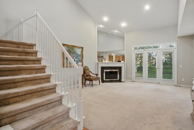 17280 Breckenridge Dr, Clinton Township, MI 48038 - stairway featuring a high ceiling, carpet floors, a tiled fireplace, baseboards, and recessed lighting