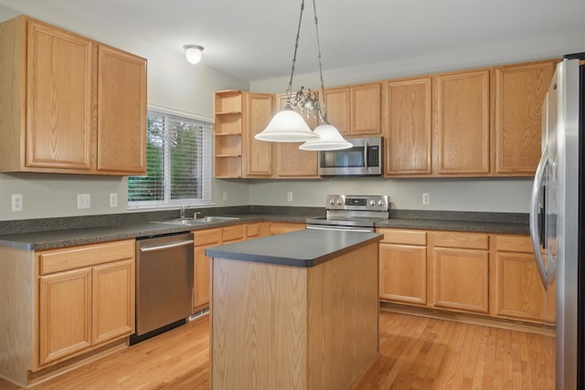17280 Breckenridge Dr, Clinton Township, MI 48038 - kitchen featuring appliances with stainless steel finishes, a sink, dark countertops, a center island, and light wood-style flooring