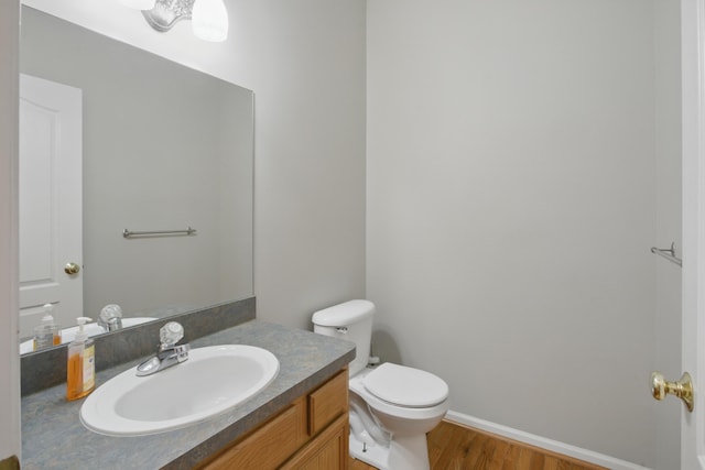 17280 Breckenridge Dr, Clinton Township, MI 48038 - half bath with vanity, toilet, wood finished floors, and baseboards