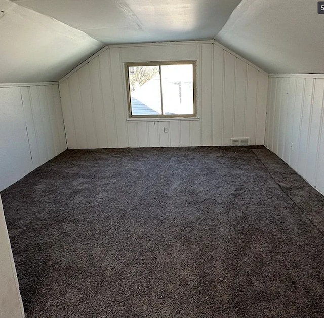 8855 Vaughan St, Detroit, MI 48228 - bonus room with lofted ceiling, dark colored carpet, and wood walls