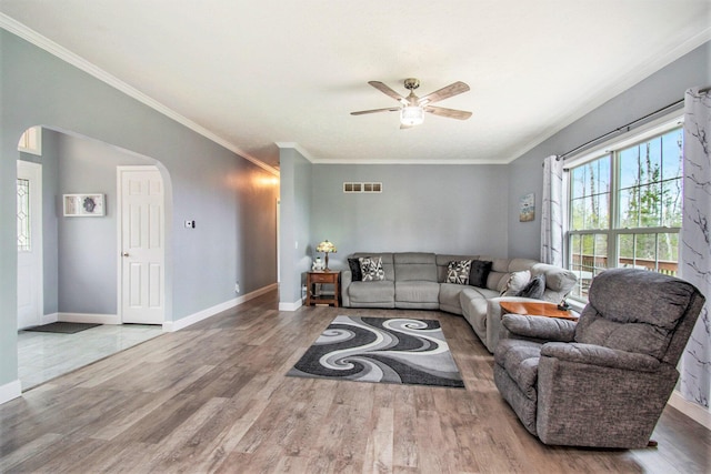 19378 Hackett Lake Highway, Onaway, MI 49765 - living area with arched walkways, a ceiling fan, wood finished floors, ornamental molding, and baseboards