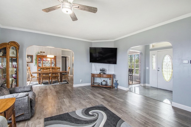 19378 Hackett Lake Highway, Onaway, MI 49765 - living area with arched walkways, ceiling fan, wood finished floors, ornamental molding, and baseboards