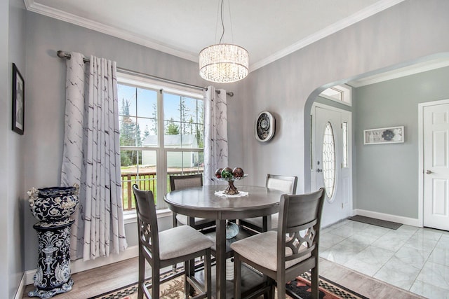 19378 Hackett Lake Highway, Onaway, MI 49765 - dining area with arched walkways, crown molding, a chandelier, and baseboards