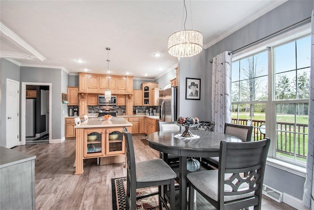 19378 Hackett Lake Highway, Onaway, MI 49765 - dining room featuring crown molding, healthy amount of natural light, a chandelier, baseboards, and recessed lighting