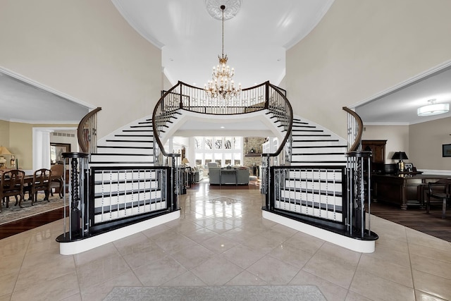 5001 Forest Vly, Clarkston, MI 48348 - stairs featuring crown molding, tile patterned flooring, a towering ceiling, and a chandelier