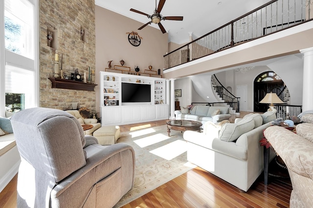 5001 Forest Vly, Clarkston, MI 48348 - living room with a high ceiling, a ceiling fan, stairs, hardwood / wood-style flooring, and a stone fireplace