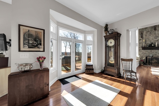 5001 Forest Vly, Clarkston, MI 48348 - foyer featuring hardwood / wood-style floors, ornate columns, a fireplace, and baseboards