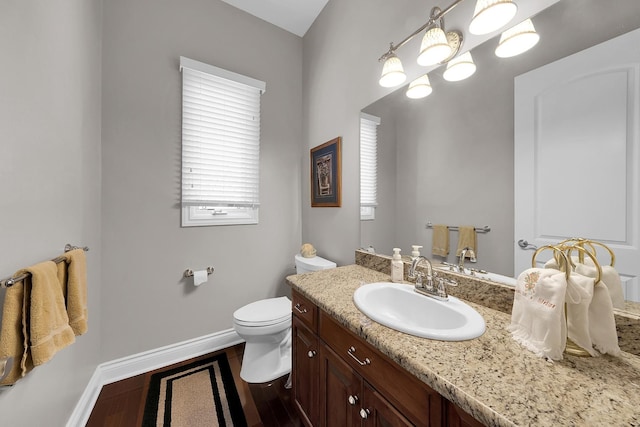 5001 Forest Vly, Clarkston, MI 48348 - half bath featuring baseboards, vanity, toilet, and wood finished floors