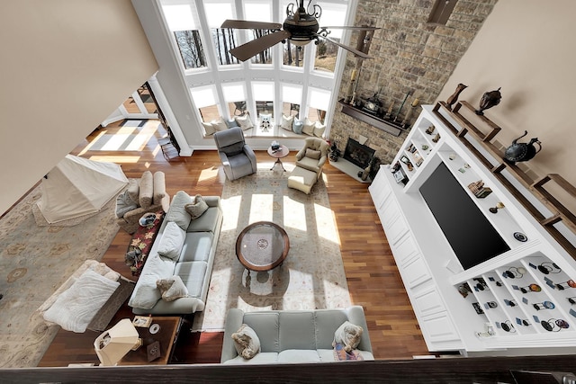 5001 Forest Vly, Clarkston, MI 48348 - living area featuring ceiling fan, a stone fireplace, wood finished floors, and a towering ceiling
