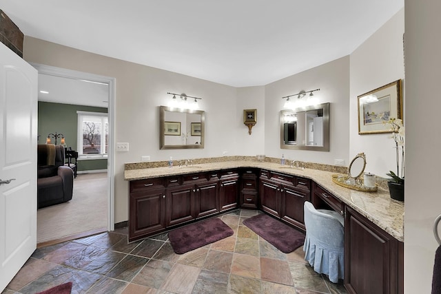5001 Forest Vly, Clarkston, MI 48348 - bathroom featuring stone tile floors, double vanity, and baseboards