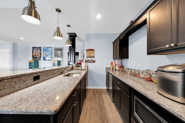 5001 Forest Vly, Clarkston, MI 48348 - kitchen featuring light wood finished floors, a sink, light stone countertops, baseboards, and pendant lighting
