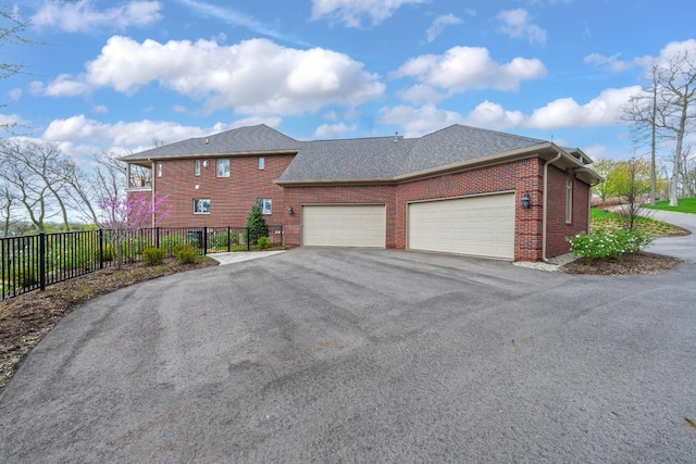 5001 Forest Vly, Clarkston, MI 48348 - view of side of home featuring driveway, a garage, brick siding, fence, and roof with shingles