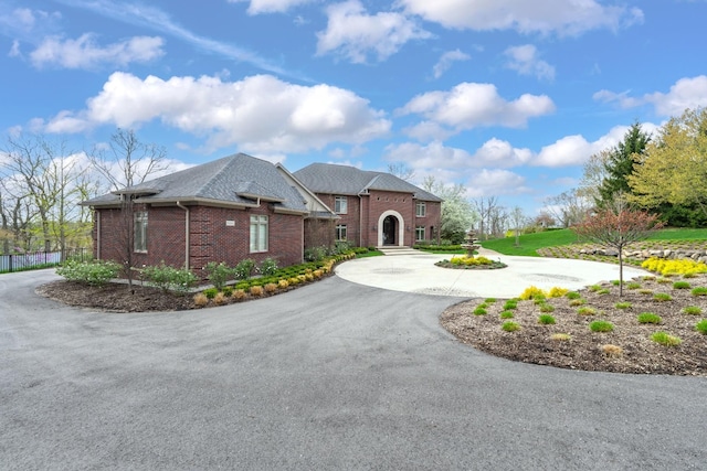 5001 Forest Vly, Clarkston, MI 48348 - view of front of home featuring curved driveway, brick siding, and fence