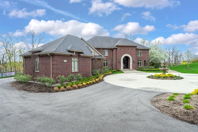 5001 Forest Vly, Clarkston, MI 48348 - view of front of property featuring curved driveway, brick siding, and a shingled roof