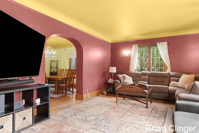 117 Palmer St NE, Grand Rapids, MI 49505 - living area with arched walkways, wood finished floors, and baseboards