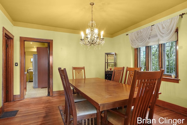 117 Palmer St NE, Grand Rapids, MI 49505 - dining space featuring a chandelier, light wood-style flooring, and baseboards