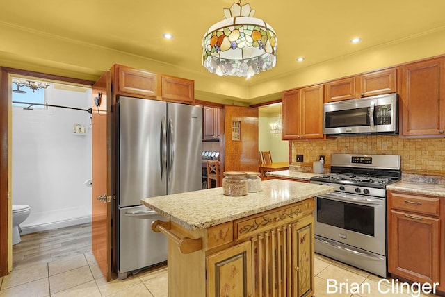 117 Palmer St NE, Grand Rapids, MI 49505 - kitchen featuring appliances with stainless steel finishes, light tile patterned floors, a kitchen island, decorative backsplash, and ornamental molding