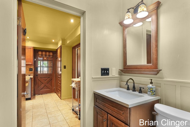 117 Palmer St NE, Grand Rapids, MI 49505 - bathroom featuring tile patterned flooring, toilet, vanity, and crown molding