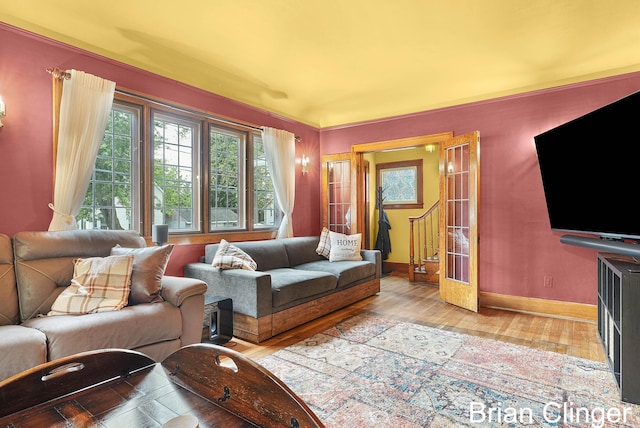 117 Palmer St NE, Grand Rapids, MI 49505 - living room featuring baseboards, light wood-style flooring, and stairway