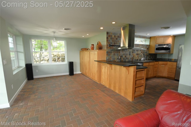 58282 Savage Rd, Vandalia, MI 49095 - kitchen with island range hood, a peninsula, appliances with stainless steel finishes, baseboards, and tasteful backsplash