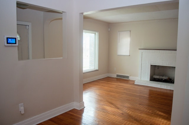 5790 Lakepointe St, Detroit, MI 48224 - unfurnished living room with baseboards, wood finished floors, ornamental molding, and a fireplace