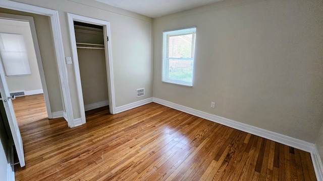 5790 Lakepointe St, Detroit, MI 48224 - unfurnished bedroom featuring wood finished floors, baseboards, and a closet