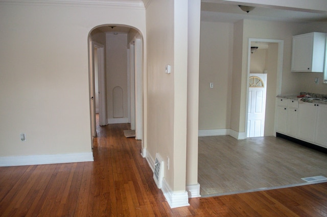 5790 Lakepointe St, Detroit, MI 48224 - hall with arched walkways, wood finished floors, baseboards, and a sink
