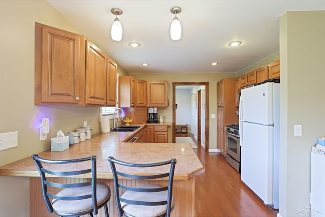6115 N Belsay Rd, Flint, MI 48506 - kitchen with freestanding refrigerator, a sink, gas stove, light countertops, and a peninsula