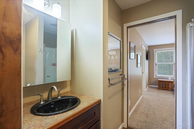 6115 N Belsay Rd, Flint, MI 48506 - bathroom featuring baseboards, vanity, and a shower with shower door