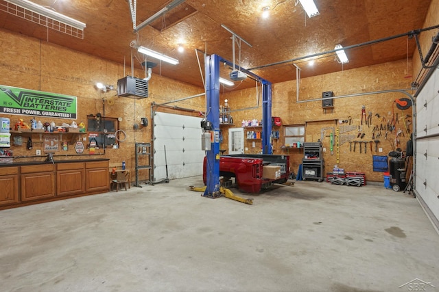 6115 N Belsay Rd, Flint, MI 48506 - garage with a workshop area and a garage door opener