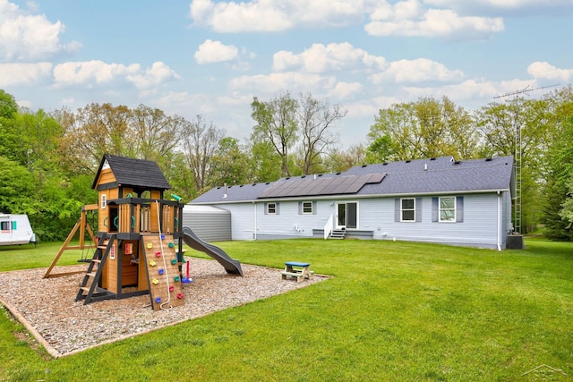6115 N Belsay Rd, Flint, MI 48506 - rear view of house featuring a playground, a lawn, entry steps, and cooling unit