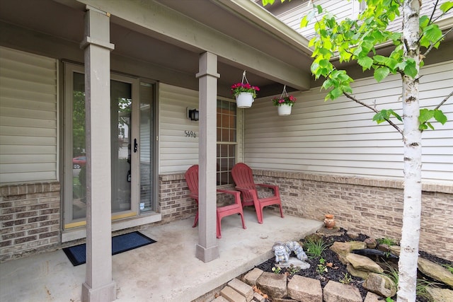 5496 Michael Dr, Ypsilanti, MI 48197 - view of exterior entry featuring brick siding and covered porch