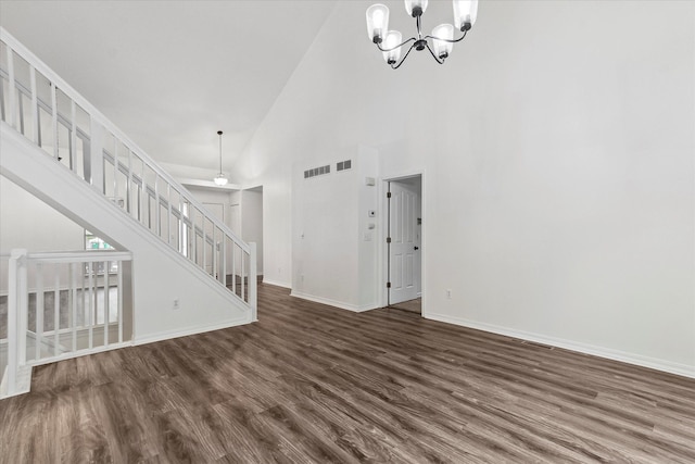 5496 Michael Dr, Ypsilanti, MI 48197 - unfurnished living room with dark wood-style flooring, a chandelier, baseboards, high vaulted ceiling, and stairway