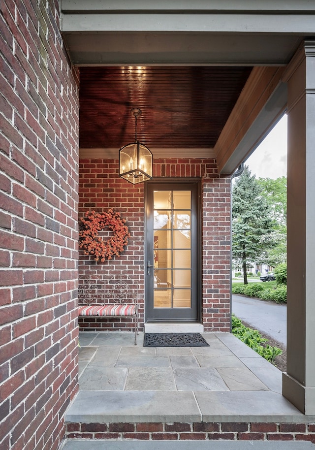 316 Chesterfield Ave, Birmingham, MI 48009 - view of exterior entry featuring brick siding and covered porch