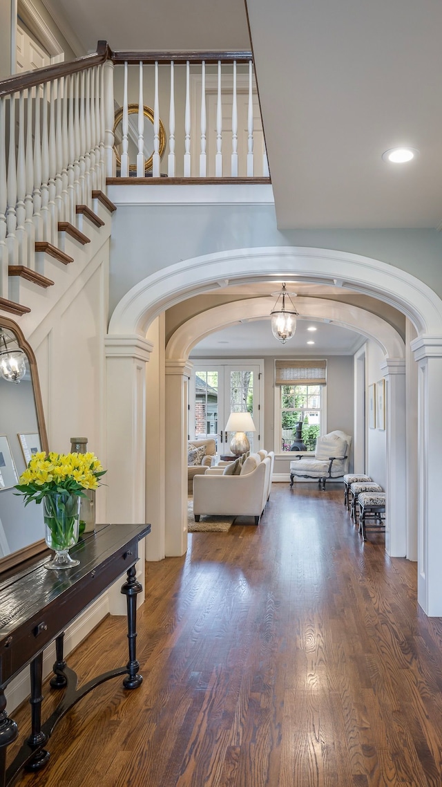 316 Chesterfield Ave, Birmingham, MI 48009 - entrance foyer with arched walkways, decorative columns, wood finished floors, and recessed lighting