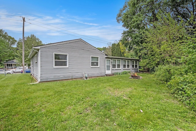 808 Woolsey Dr SW, Grand Rapids, MI 49503 - back of house with a yard and a fire pit